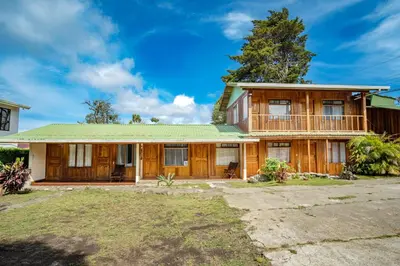 a house with a green roof at Cowboy Hostel - Habitaciones con Baño Privado in Monteverde Costa Rica