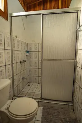 a bathroom with a toilet and a shower at Cowboy Hostel - Habitaciones con Baño Privado in Monteverde Costa Rica