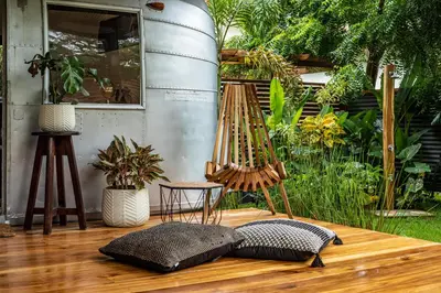 a wooden deck with a chair and some plants at La Caravana in Sámara