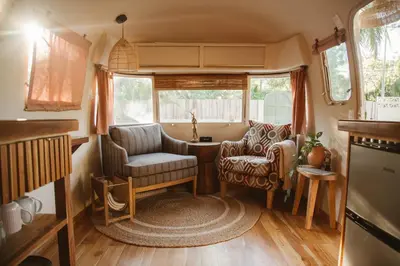 a living room with chairs and a table in a caravan at La Caravana in Sámara