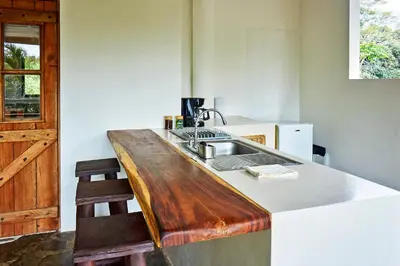 a kitchen with a wooden counter top and a sink at Villa Ananda in Mal País