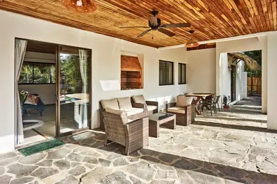 a patio with chairs and a ceiling fan at Villa Ananda in Mal País