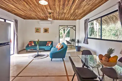 a living room with a blue couch and a table at Villa Ananda in Mal País