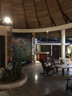 a mural on the side of a building with a pool table at Pura Vida Hostel in Tamarindo