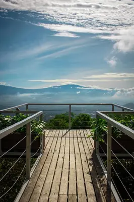 a wooden deck with a view of the ocean at Barons Resort in Atenas