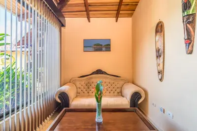 a living room with a couch and a table at Barons Resort in Atenas