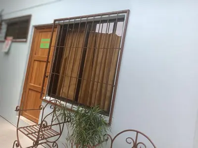 a wooden door with a plant in front of it at Apartamentos M&M in Fortuna