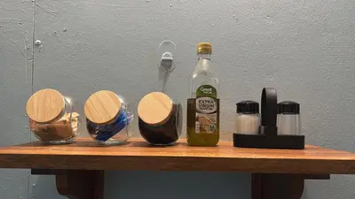 a bottle of alcohol sitting on top of a wooden table at Apartamentos M&M in Fortuna
