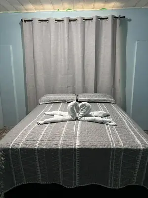 a bed with two white towels on top of it at Apartamentos M&M in Fortuna