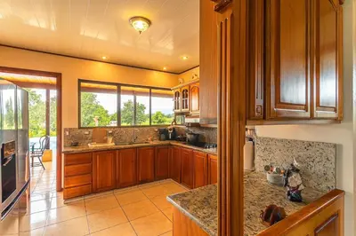 a kitchen with wooden cabinets and a counter top at Casa Stela in Fortuna