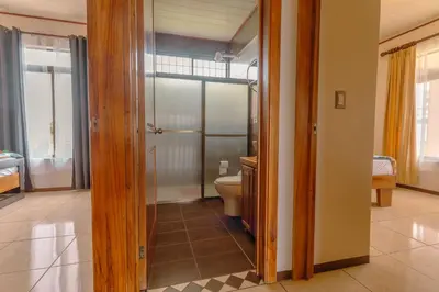 a bathroom with a toilet and a glass door at Casa Stela in Fortuna
