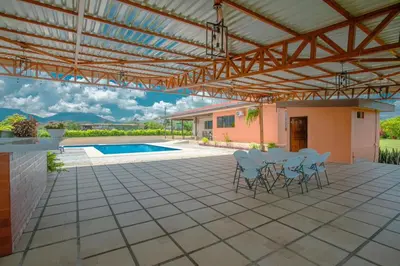 a patio with chairs and a table and a pool at Casa Stela in Fortuna