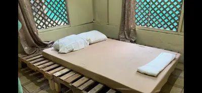 a bed with two pillows on it in a room at Beach Guesthouse in Manuel Antonio