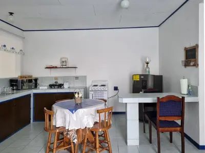 a kitchen with a table and some chairs in a room at Entire Homy apartment for you, 5 min SJO Airport in Alajuela City