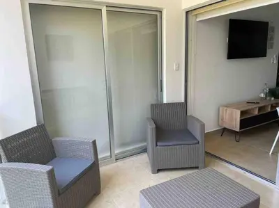 a living room with three chairs and a television at Bejuco Beachfront Condo FRENTE A LA PLAYA hermoso condominio NUEVO in Esterillos Este