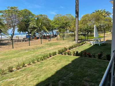 a view of a park with a table and umbrella at Bejuco Beachfront Condo FRENTE A LA PLAYA hermoso condominio NUEVO in Esterillos Este