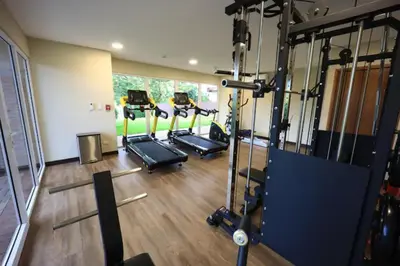 a gym with several tread machines in a room at Tropical Luxury 2Bdr condo - Pool view - At the Beach in Tamarindo