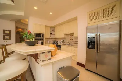 a kitchen with a counter and a refrigerator at Bella Vista 2D 3 bdrs pool view in Los Suenos in Herradura