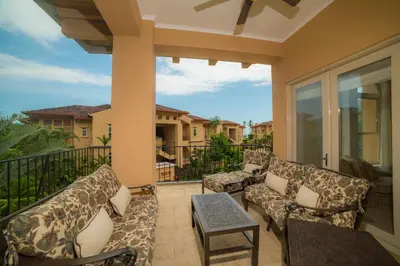 a patio with couches and a table and a balcony at Bella Vista 2D 3 bdrs pool view in Los Suenos in Herradura
