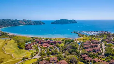an aerial view of a resort on the shore of a lake at Bella Vista 2D 3 bdrs pool view in Los Suenos in Herradura
