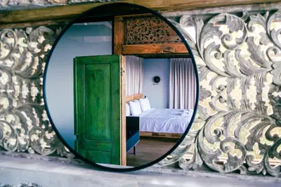 a mirror reflection of a bedroom with a bed at THEA Resort & Retreats - Santa Teresa in Santa Teresa Beach