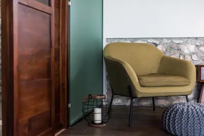a chair sitting in a room next to a door at THEA Resort & Retreats - Santa Teresa in Santa Teresa Beach