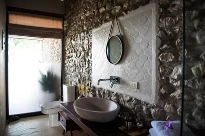 a bathroom with a sink and a mirror on the wall at THEA Resort & Retreats - Santa Teresa in Santa Teresa Beach
