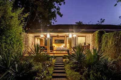 a house with a pathway leading to the front yard at THEA Resort & Retreats - Santa Teresa in Santa Teresa Beach