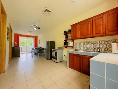 a kitchen with wooden cabinets and a counter top at Hermosa Paradise in Playa Hermosa