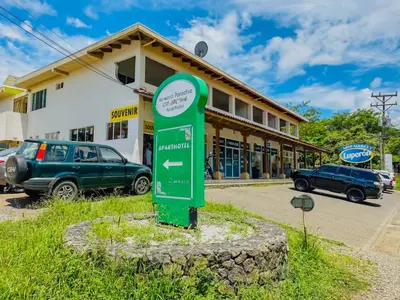 a green sign in front of a building at Hermosa Paradise in Playa Hermosa