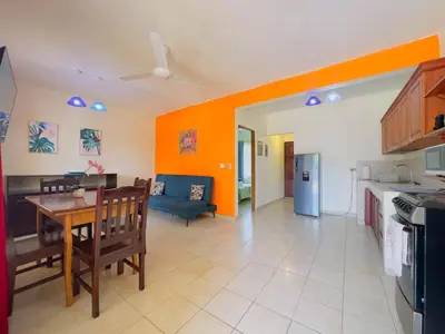 a kitchen and living room with a table and a couch at Hermosa Paradise in Playa Hermosa