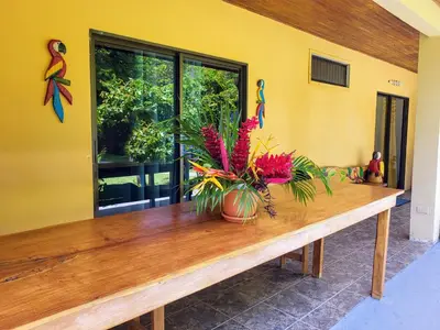 a wooden table with a vase of flowers on it at Villas Playa Palo Seco in Parrita