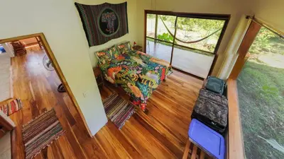 a living room with a couch and a window at Jungle Bungalow in Drake Bay in Drake