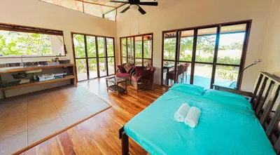 a bedroom with a bed with two towels on it at Jungle Cabin in Drake Bay in Drake