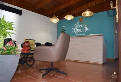 an office with a chair and a sign on the wall at Trebol Amarillo Bed & Breakfast in Escazu