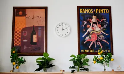 two posters and a clock on a wall at Trebol Amarillo Bed & Breakfast in Escazu