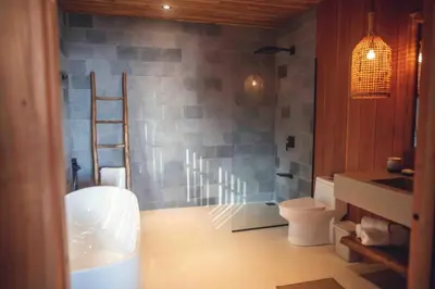 a bathroom with a ladder next to a toilet at Aguamadera Ocean View Villas in Santa Teresa Beach
