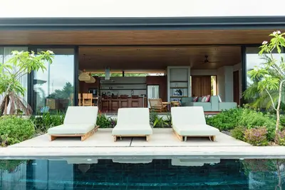 a villa with a swimming pool and a house at Aguamadera Ocean View Villas in Santa Teresa Beach