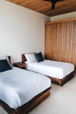 two beds sitting next to each other in a room at Aguamadera Ocean View Villas in Santa Teresa Beach
