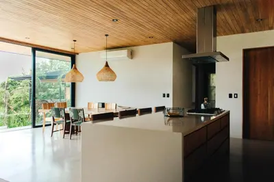 a kitchen with a large island and a dining room at Aguamadera Ocean View Villas in Santa Teresa Beach