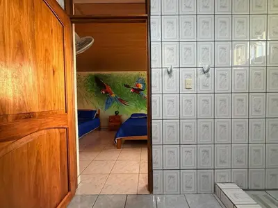 an open door to a room with a bedroom at La Tigra Mountain House in San Gerardo
