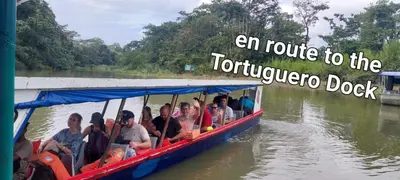 a group of people riding in a boat on the water at Hospedaje Doña koko in Puerto Limón