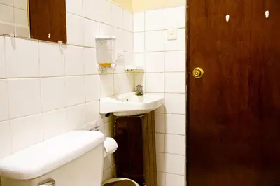 a bathroom with a toilet and a sink at Hospedaje Doña koko in Puerto Limón