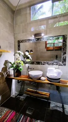 a bathroom with two sinks on a wooden counter at Canal Grande Lodge in Piedades