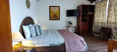 a hotel room with a bed and a chair at Canal Grande Lodge in Piedades