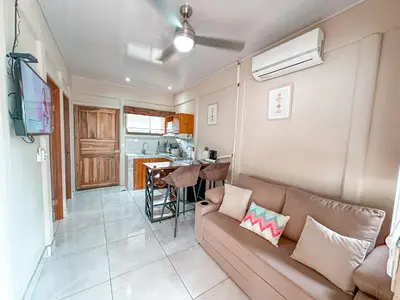 a living room with a couch and a kitchen at Casa CAXTUS in Brasilito