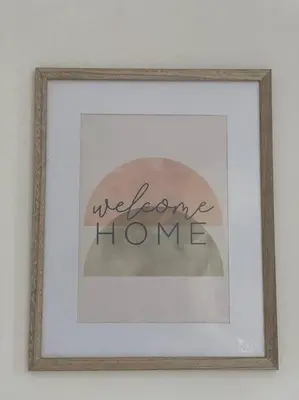 a picture of a welcome home sign in a frame at Casa Buda Liberia Cerca del Aeropuerto in Liberia