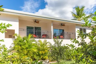 a house with two bees on the balconies at Palm Beach Inn in Playa Grande