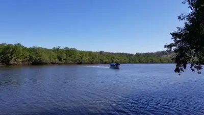 a boat in the middle of a river at Palm Beach Inn in Playa Grande