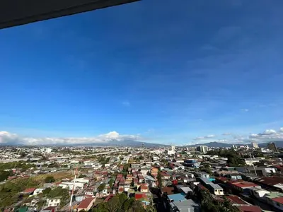 a view of a city with houses and buildings at Bambu-Rivera Club Residences in San José